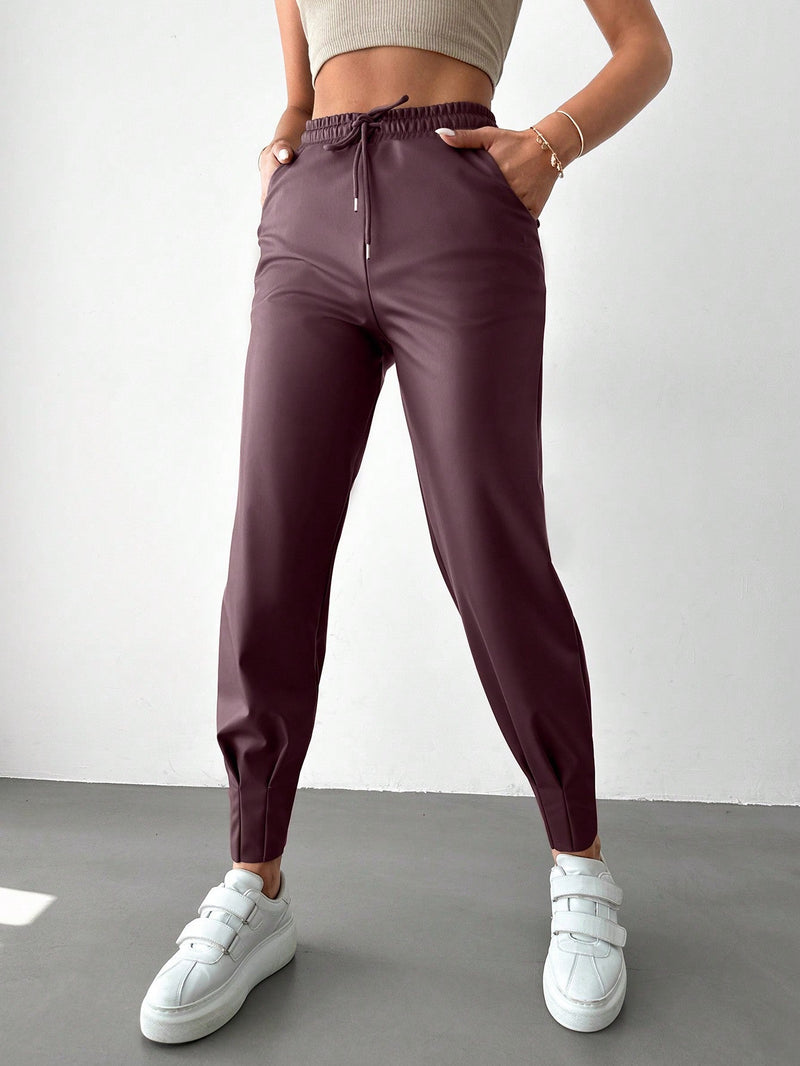 Pantalones con punos elasticos y cintura con cordon de color liso para mujer