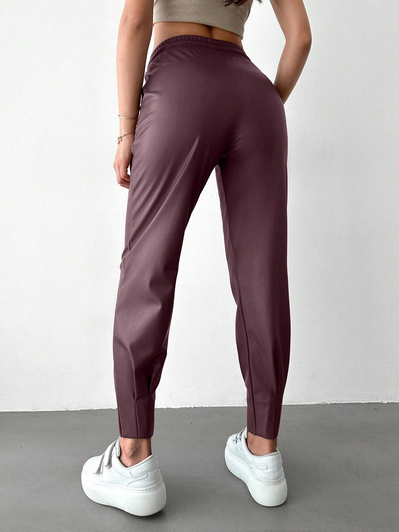 Pantalones con punos elasticos y cintura con cordon de color liso para mujer