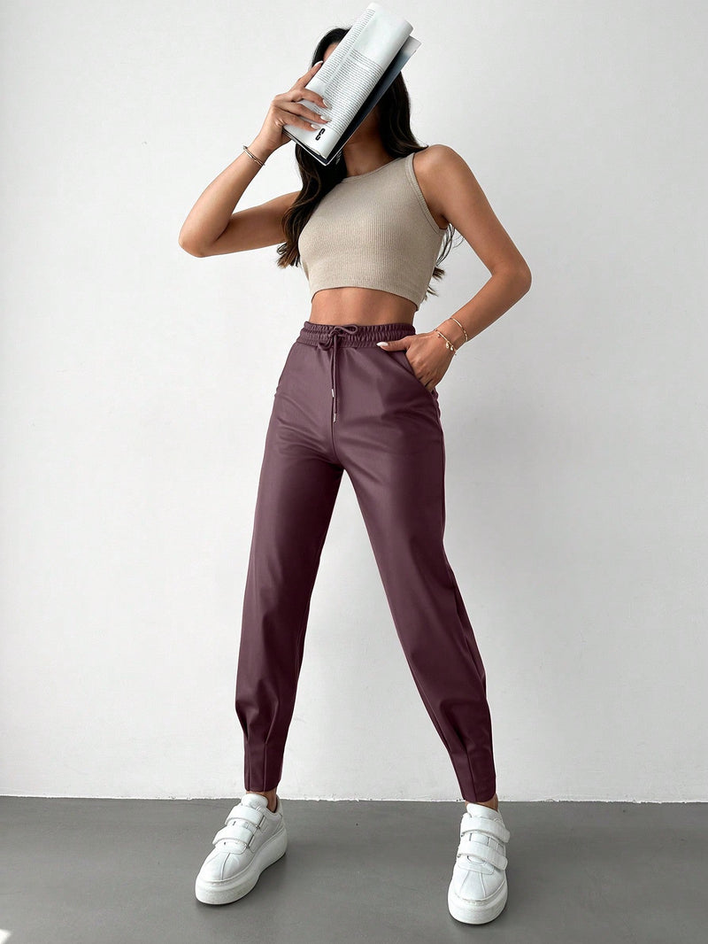 Pantalones con punos elasticos y cintura con cordon de color liso para mujer