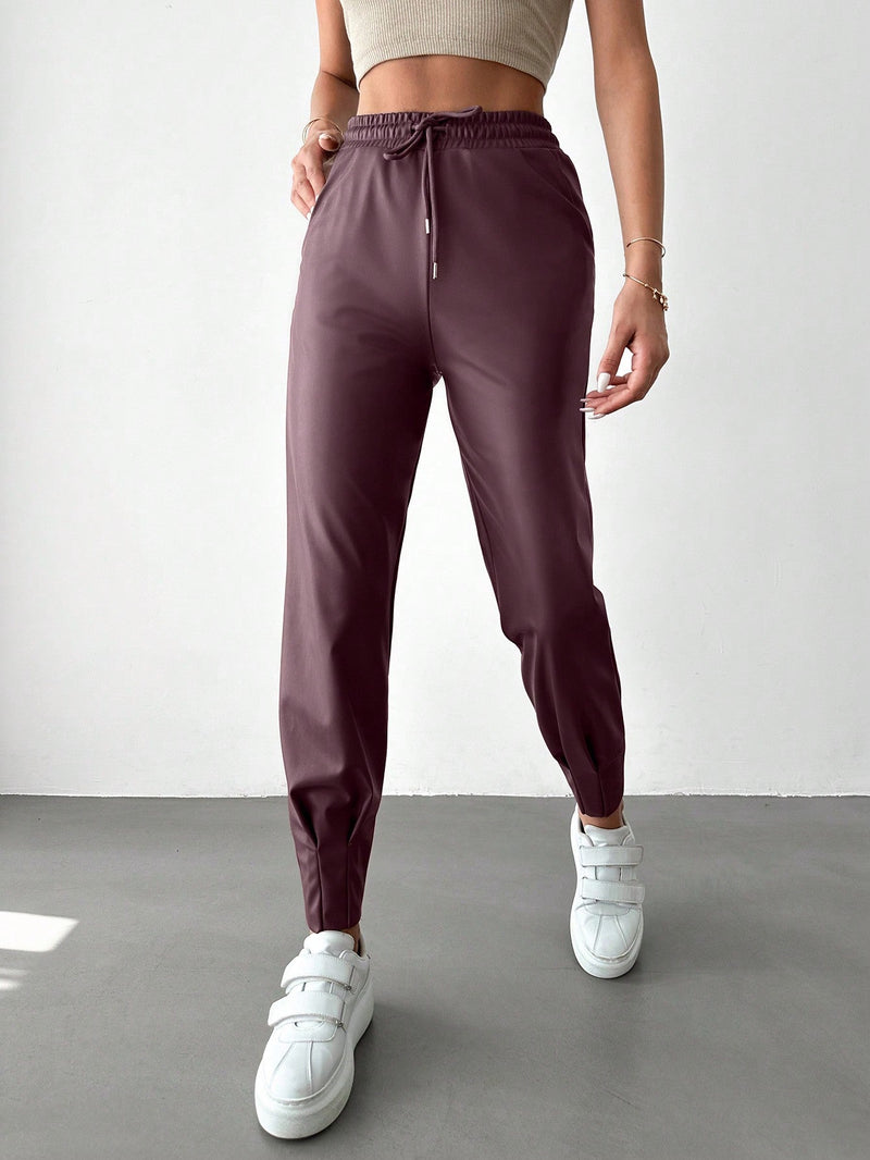 Pantalones con punos elasticos y cintura con cordon de color liso para mujer