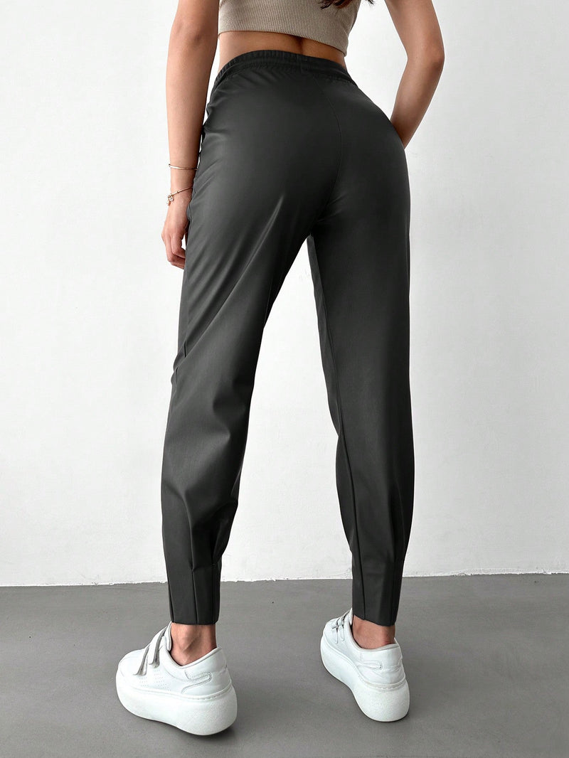 Pantalones con punos elasticos y cintura con cordon de color liso para mujer