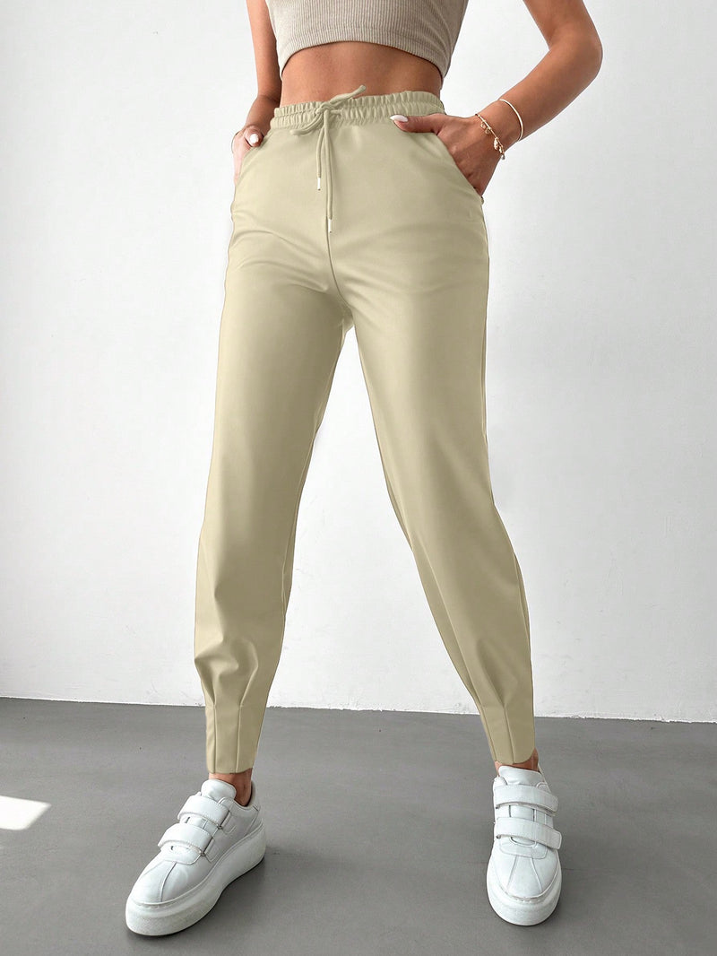 Pantalones con punos elasticos y cintura con cordon de color liso para mujer