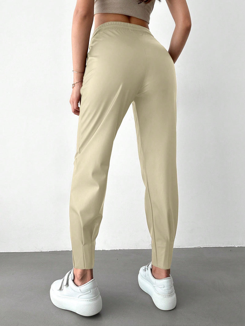 Pantalones con punos elasticos y cintura con cordon de color liso para mujer