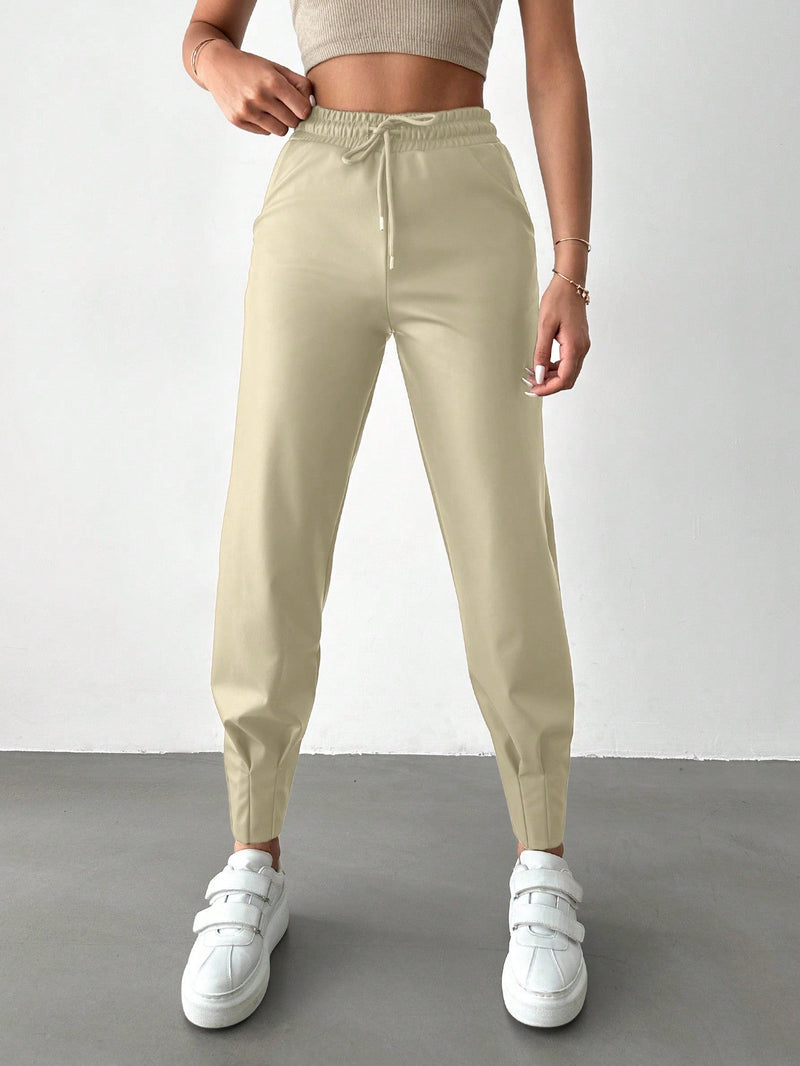 Pantalones con punos elasticos y cintura con cordon de color liso para mujer