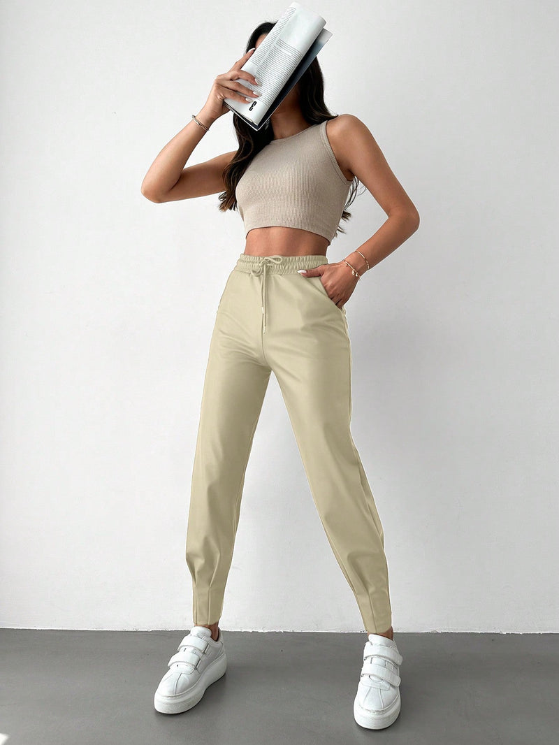 Pantalones con punos elasticos y cintura con cordon de color liso para mujer