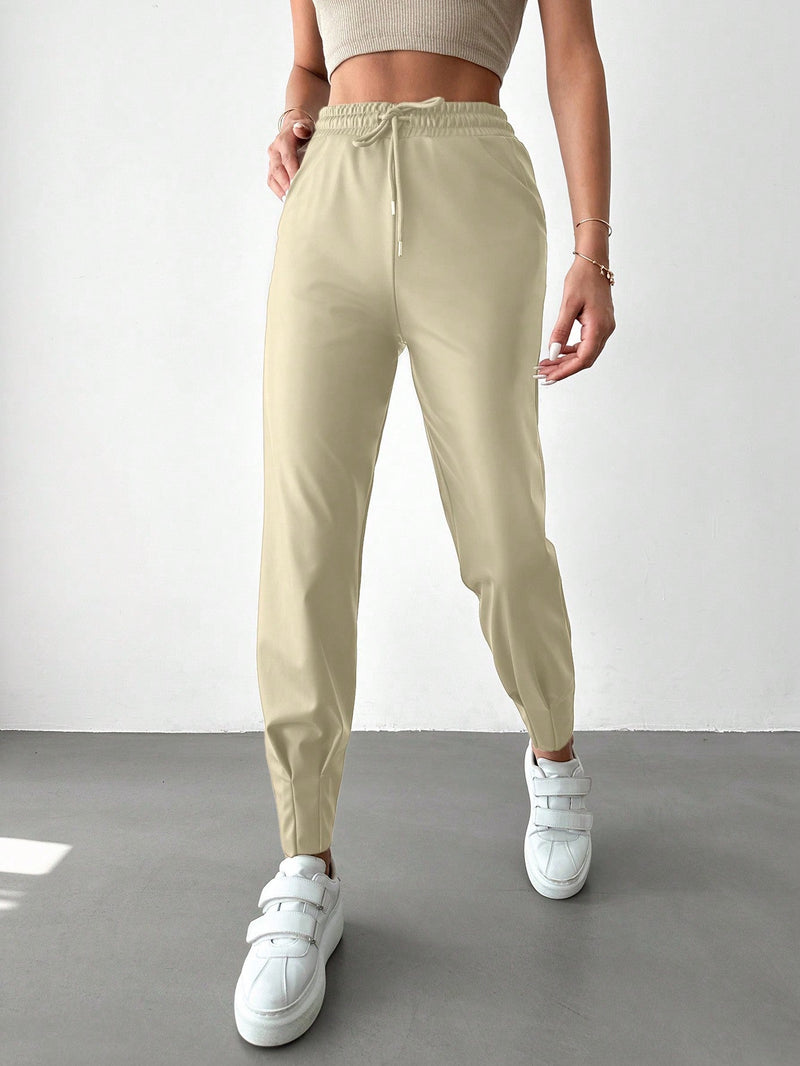 Pantalones con punos elasticos y cintura con cordon de color liso para mujer