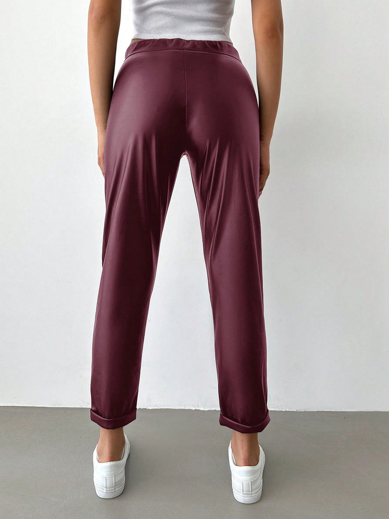 Pantalones largos de tela metalica con nudo frontal para mujer