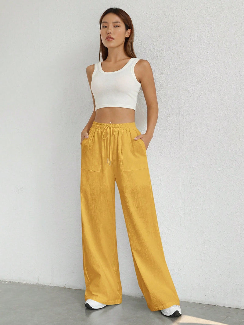 Pantalones sueltos de pierna ancha de color solido para mujer con dobladillo fluido, estilo casual