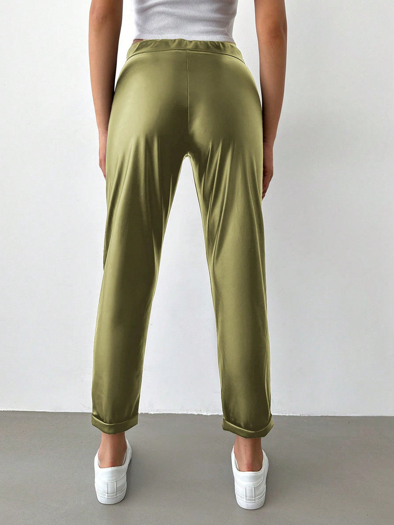 Pantalones largos de tela metalica con nudo frontal para mujer