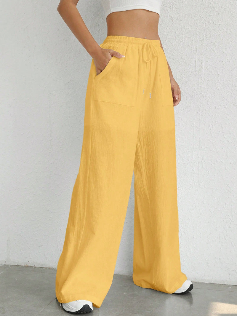 Pantalones sueltos de pierna ancha de color solido para mujer con dobladillo fluido, estilo casual