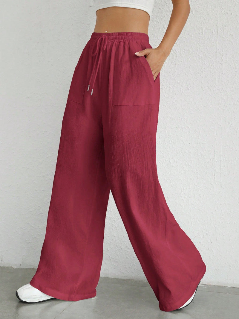 Pantalones sueltos de pierna ancha de color solido para mujer con dobladillo fluido, estilo casual