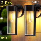 2 luces de pared solares para exteriores con bombillas de filamento de wolframio - Diseño moderno y elegante en negro, sensor automático para jardín, césped, patio, garaje y puerta principal, iluminación decorativa, luces solares para exteriores, ilumina